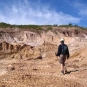 Colour photograph of a man walking across white rocks in the quarry
