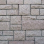 Colour photograph of rock wall with square and rectangular set stones