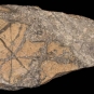 Colour image of brown rocks with light brown facing crossed with brown stripes