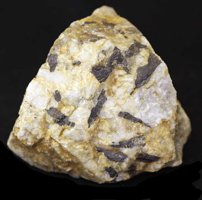 Colour image of yellow rock with black and white spots and marks