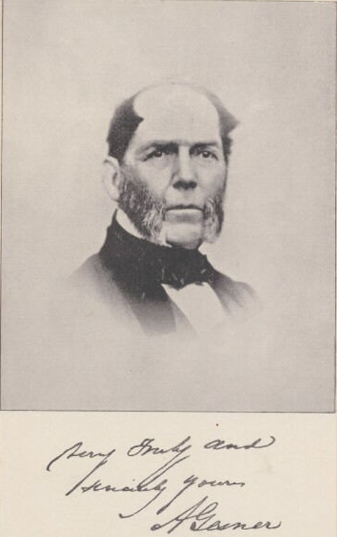 Black and white photograph of a balding man with whiskers