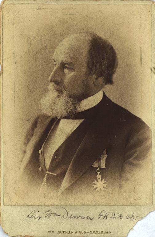 Black and white photograph of a man with a beard and wearing a suit